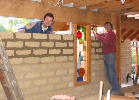 tim and jonni installing laying bricks